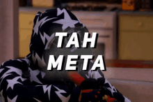 a person wearing a hoodie with the words tah meta written on the bottom