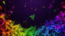 the razer logo is surrounded by a rainbow of colors on a dark background .