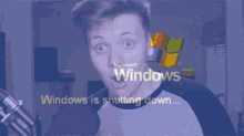 a man with a surprised look on his face is looking at a screen that says windows is shutting down