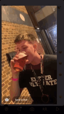 a man drinking a beer wearing a shirt that says ever ultimate