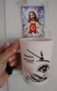 a person holding a mug that says complete your look on it