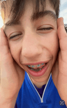 a young boy with braces on his teeth is making a face