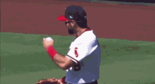 a baseball player wearing sunglasses and a white jersey with the word angels on it is standing on a baseball field .