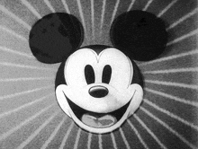 a black and white image of mickey mouse smiling