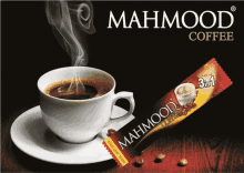 a cup of mahmood coffee sits on a saucer next to a package