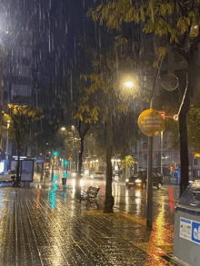 a rainy street with a sign that says " atencion atencion "