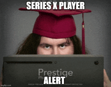 a man in a graduation cap is holding a prestige alert