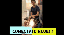 a man sitting on a couch with sparklers in front of him and the words conectate buje !!!