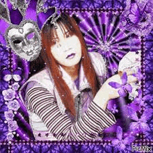 a woman is holding a purple flower in front of a purple background with a mask .