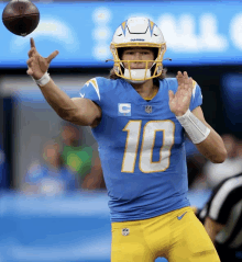 a football player with the number 10 on his jersey throws the ball