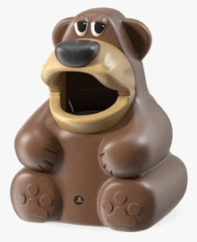 a brown teddy bear shaped trash can with its mouth open on a white background .