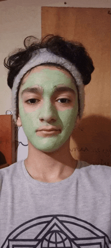 a boy wearing a headband and a green face mask