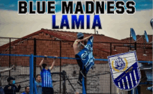 a poster for blue madness lamia shows a shirtless man holding a flag