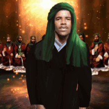 a man with a green turban stands in front of a group of men