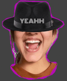 a woman wearing a black hat with yeahh written on it