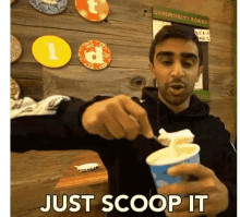 a man scooping ice cream from a cup with the words just scoop it below him