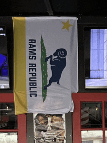 a rams republic flag hangs from a window