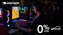 a man wearing headphones is playing a video game on a computer with an advertisement for ibuypower behind him