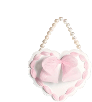 a heart shaped purse with a pink bow and pearls on a white background