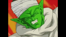 piccolo from dragon ball z is a green alien with a bandaged head .