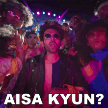 a man in sunglasses stands in front of a crowd and says aisa kyun