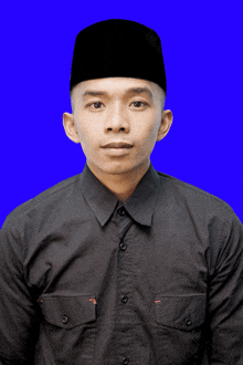 a man wearing a black shirt and a black hat is standing in front of a blue background