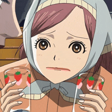 a girl with a scarf around her head holds a glass with strawberries on it