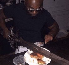 a man is cutting chicken with a large sword