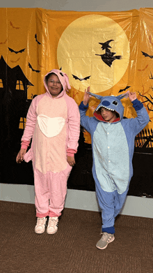 a girl in a pink bunny costume and a boy in a blue stitch costume