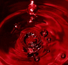 a splash of red liquid with bubbles coming out of it