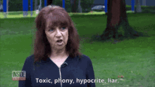 a woman says " toxic phony hypocrite liar " while standing in the grass