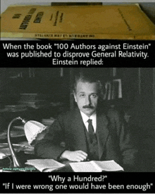 a man in a suit and tie is sitting at a desk in front of a book that says 100 authors against einstein