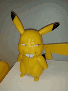 a yellow pikachu toy with a funny face on it