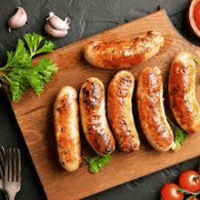 a wooden cutting board topped with sausages , tomatoes , garlic , and parsley .