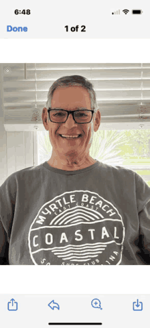 a man wearing a shirt that says myrtle beach coastal is smiling