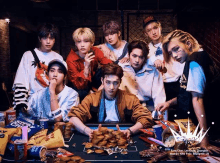 a group of young men standing around a poker table with chips and coins