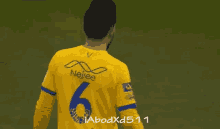 a man in a yellow jersey with the number 6 on it