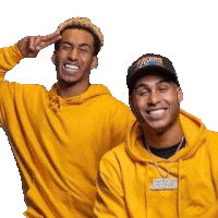 a couple of men wearing yellow hoodies and hats are standing next to each other and smiling .