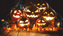 a group of halloween pumpkins are lit up on a table