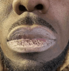 a close up of a man 's mouth with a picture of jesus on his lips