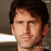 a close up of a man 's face with faceapp written on the bottom right