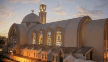 a large white building with stained glass windows and a cross on top