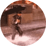 a man is walking in the rain with an umbrella .