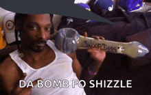 snoop dogg is holding a snoop dogg pipe and says da bomb fo shizzle