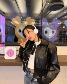 a woman wearing headphones stands in front of a cd player that says twice on it