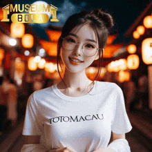 a woman wearing glasses and a totomacau t-shirt