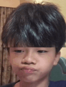 a close up of a young boy 's face with a blurred background