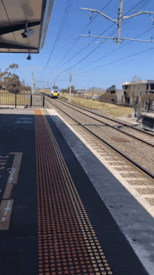 a train is pulling into a station with a sign that says ' sydney ' on it