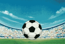 a soccer ball is spinning on a field in front of a stadium