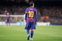 a soccer player wearing a jersey with the number 10 on it is walking on the field .